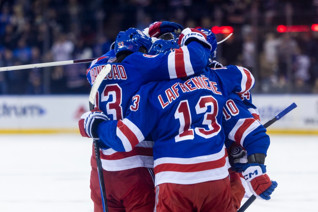 New York Rangers players Mika Zibanejad and Alexis Lafrenière celebrating a goal.