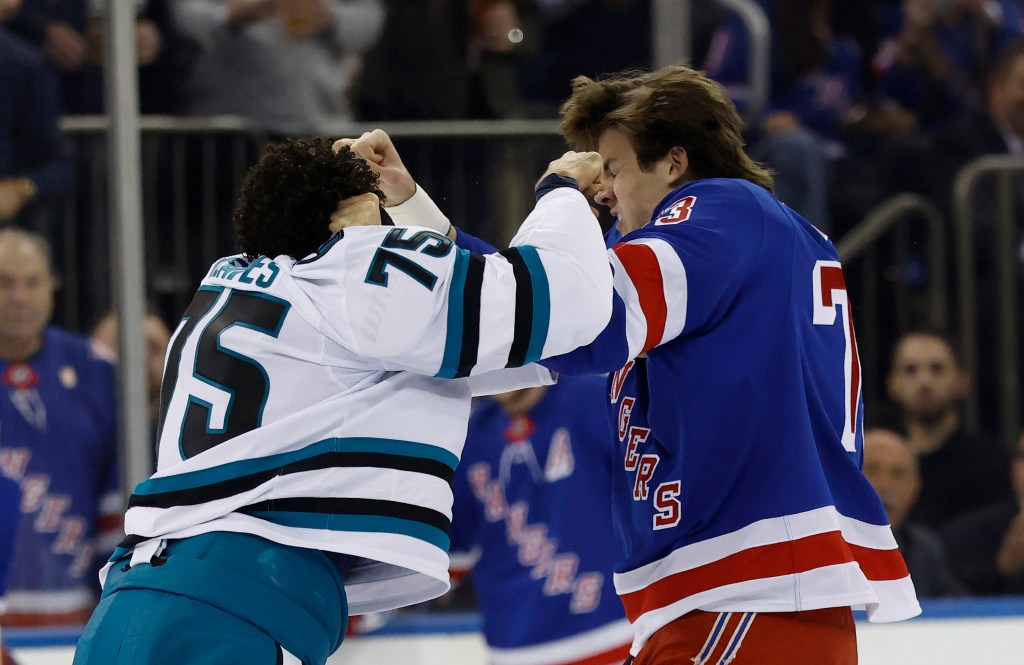 New York Rangers center Matt Rempe and San Jose Sharks right wing Ryan Reaves fighting during a hockey game.