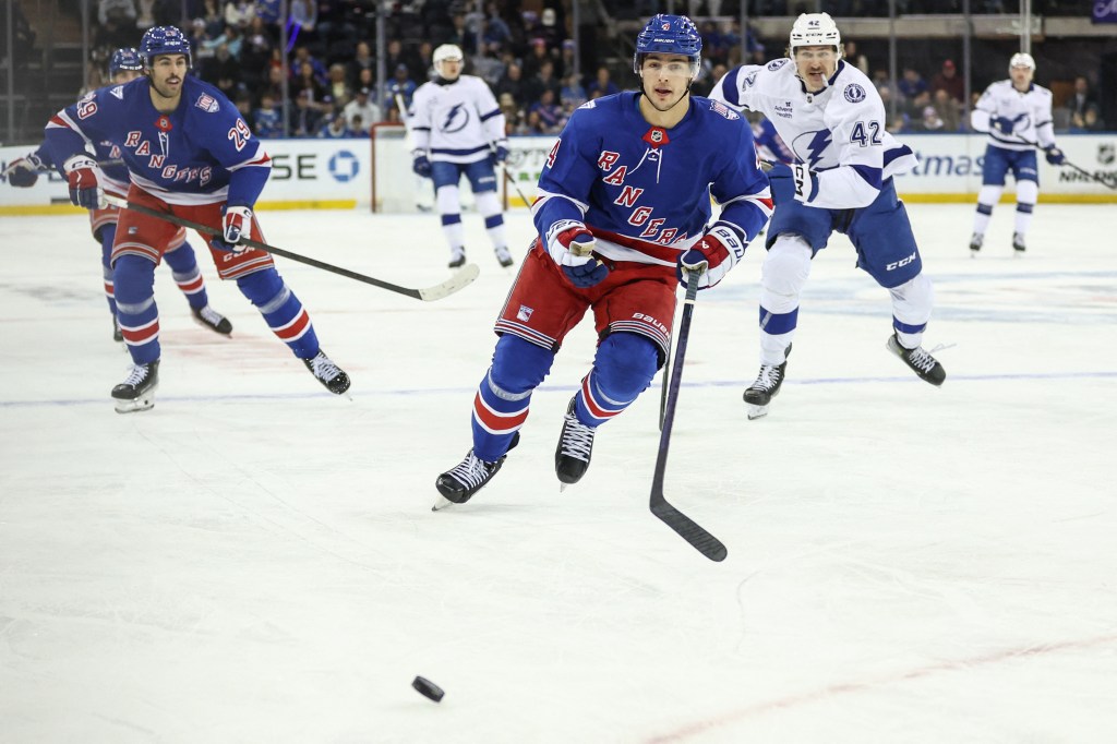 New York Rangers defenseman Braden Schneider (4) chases the puck in the first period against the Tampa Bay Lightning.