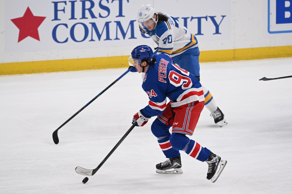 Gabe Perreault (New York Rangers #94) controls the puck as Oskar Sundqvist (St. Louis Blues #70) skates behind him.