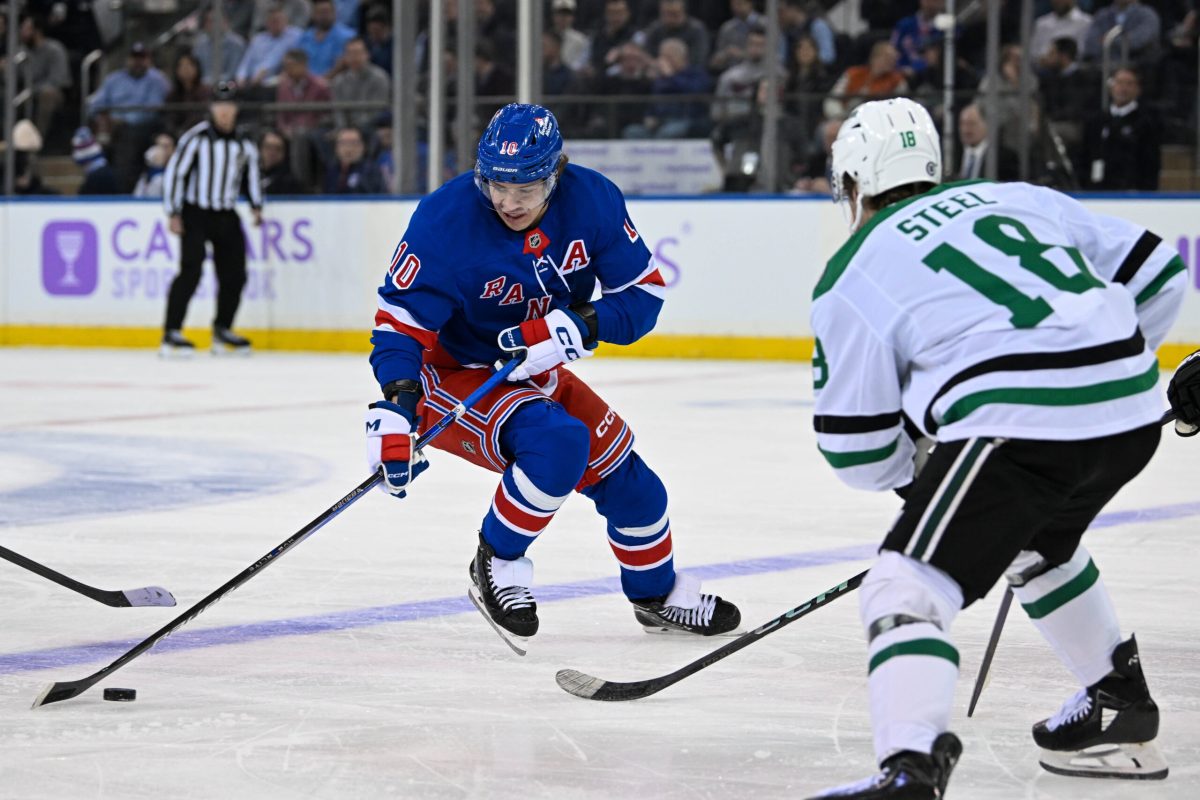 Jan 7, 2025; New York, New York, USA; New York Rangers left wing Artemi Panarin (10) skates with the puck defended by Dallas Stars center Sam Steel (18) during the first period at Madison Square Garden. Mandatory Credit: Dennis Schneidler-Imagn Images