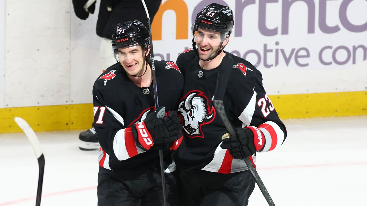 Buffalo Sabres center Ryan McLeod, left, celebrates his empty net goal with defenseman Mattias Samuelsson (23). (AP Photo/Jeffrey T. Barnes)