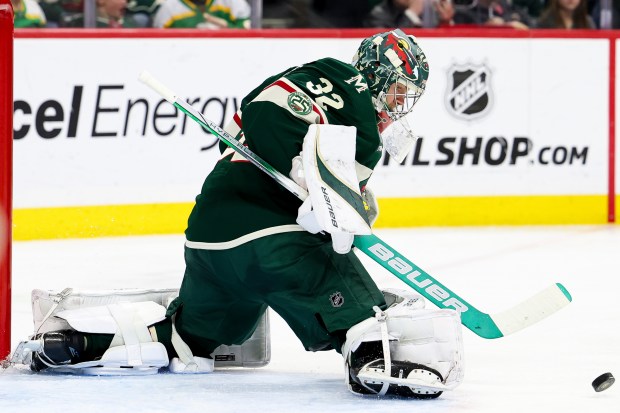 Minnesota Wild goaltender Filip Gustavsson (32) makes a save during the second period of an NHL hockey game against the Vancouver Canucks, Saturday, Nov. 1, 2025, in St. Paul, Minn. (AP Photo/Ellen Schmidt)