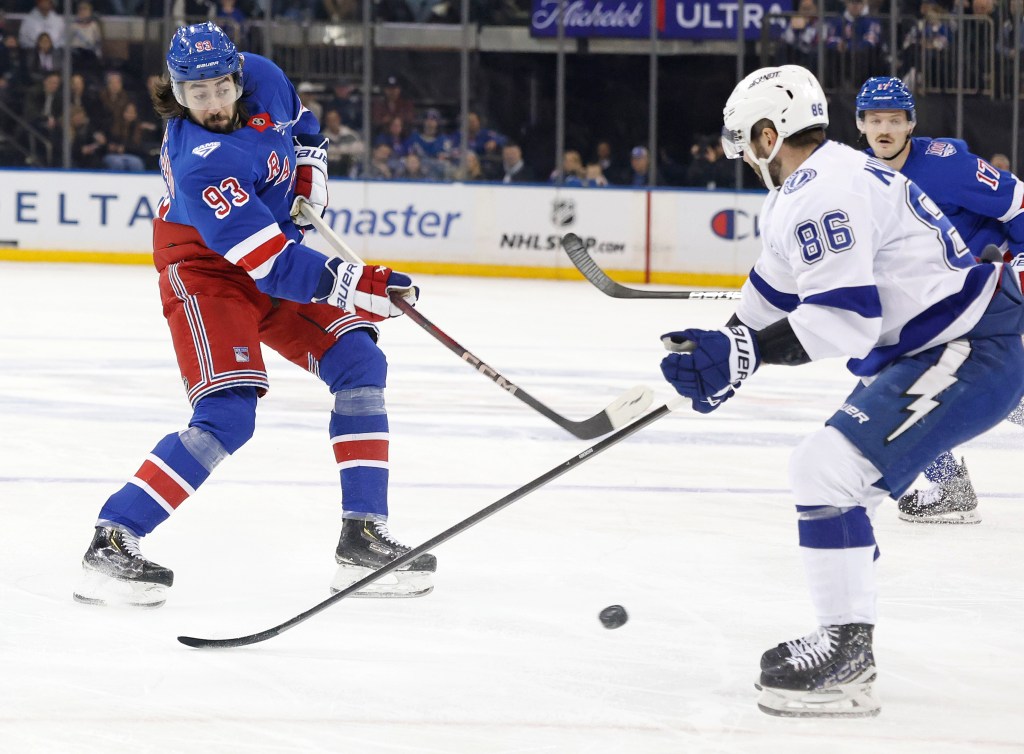 New York Rangers center Mika Zibanejad (93) takes a shot as Tampa Bay Lightning right wing Nikita Kucherov (86) defends.