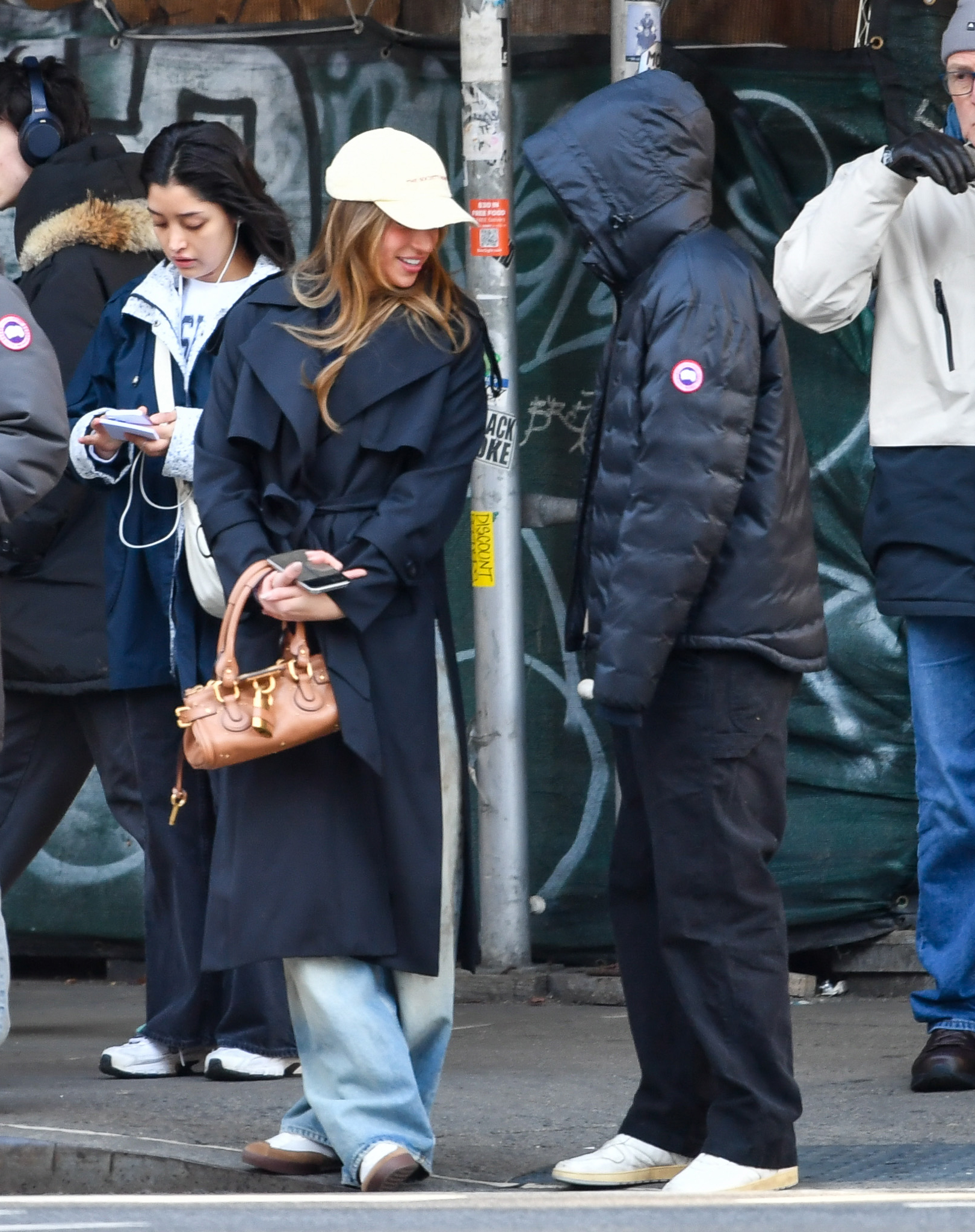 McRae accesorized with a Chloe bag, while Hughes wore a Canada Goose puffer jacket to keep warm.