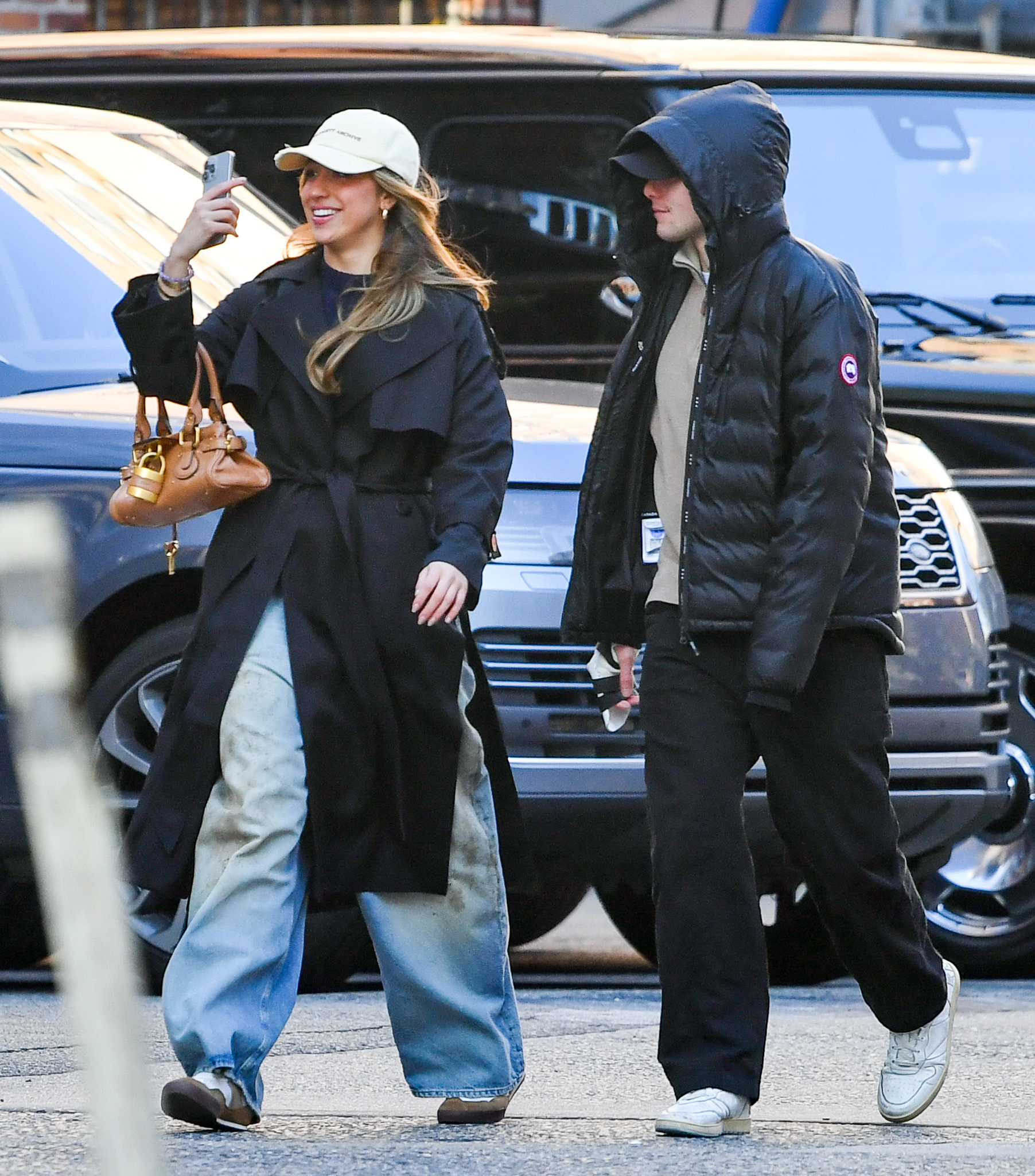 Tate McRae wears a black trench coat, jeans, and chloe sneakers on her date with Jack Hughes.