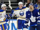Buffalo Sabres' Rasmus Dahlin (centre) celebrates his goal with Tyson Kozak (48) as Toronto Maple Leafs' Nicholas Robertson (89) skates during second period NHL action in Toronto on Jan. 27, 2026. 