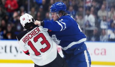 Toronto Maple Leafs left wing Matthew Knies (23) fights with New Jersey Devils center Nico Hischier (13): Nick Turchiaro-Imagn Images