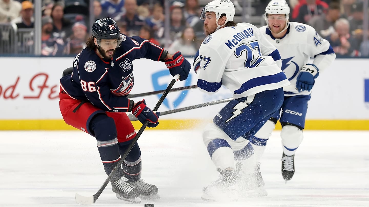 Blue Jackets forward Kirill Marchenko makes a move past Lightning defenseman Ryan McDonagh.