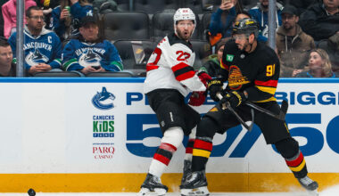 New Jersey Devils defenseman Brett Pesce (22) battles Vancouver Canucks forward Evander Kane (91): Bob Frid-Imagn Images