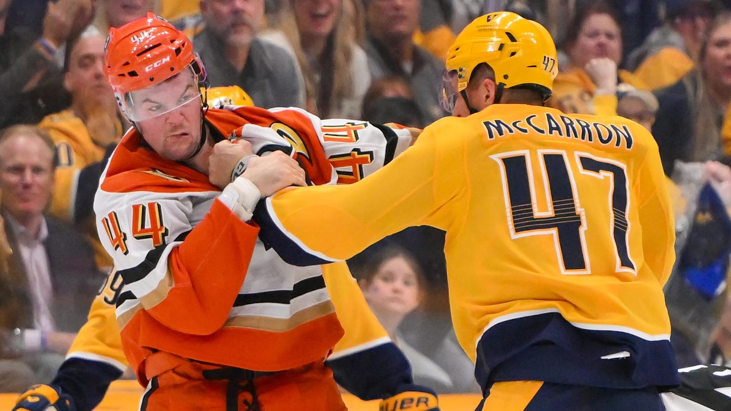 Oct 21, 2025; Nashville, Tennessee, USA;   Anaheim Ducks left wing Ross Johnston (44) and Nashville Predators right wing Michael McCarron (47) exchange punches during the third period at Bridgestone Arena. Mandatory Credit: Steve Roberts-Imagn Images