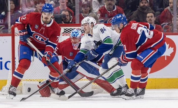  Montreal Canadiens defencemen Arber Xhekaj, left, and Kaiden Guhle team up to keep the puck away from Vancouver Canucks’ Linus Karlsson in front of Habs goalie Jakub Dobes during the third period at the Bell Centre in Montreal on Monday January 12, 2026.