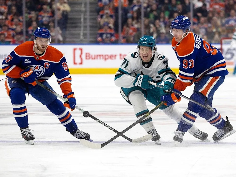 The Edmonton Oilers’ Connor McDavid (97) and Ryan Nugent-Hopkins (93) battle the San Jose Sharks’ Macklin Celebrini (71) during second period NHL action at Rogers Place, in Edmonton Thursday Jan. 29, 2026.