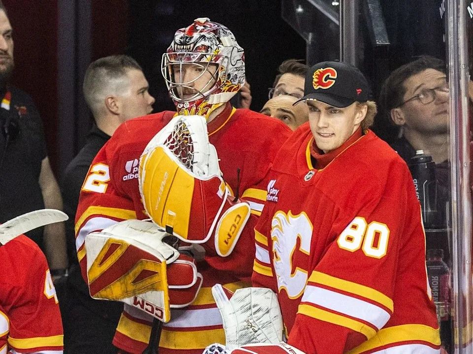  Calgary Flames goaltender Dustin Wolf and rookie goaltender Owen Say look on from the bench in the third period against the Seattle Kraken at the Scotiabank Saddledome on Monday, January 5, 2026. Brent Calver/Postmedia