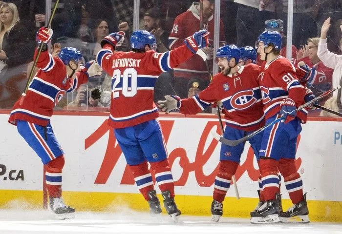  Montreal Canadiens Ivan Demidov, left, Juraj Slafkovsky and Oliver Kapanen, right, celebrate with Alexandre Carrier after Carrier scored against the Vancouver Canucks during the second period at the Bell Centre in Montreal on Monday January 12, 2026.