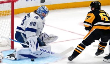 Tampa Bay Lightning goaltender Andrei Vasilevskiy (88) blocks a shot by Pittsburgh Penguins' Rickard Rakell during the first period of an NHL hockey game in Pittsburgh, Tuesday, Jan. 13, 2026. (AP Photo/Gene J. Puskar)