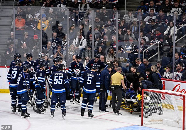 Fleury's teammates gathered around him on the ice as medical staff put him on a stretcher