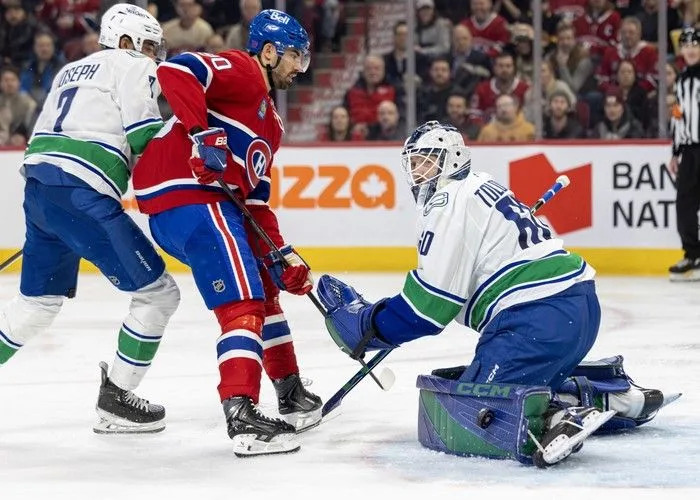  Vancouver Canucks goalie Nikita Tolopilo looks for the puck after making a save as Vancouver defenceman Pierre-Olivier Joseph checks Montreal Canadiens’ Joe Veleno during the third period at the Bell Centre in Montreal on Monday January 12, 2026.