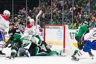 Dallas Stars goaltender Jake Oettinger (29) sprawls across the goal as defenseman Thomas...