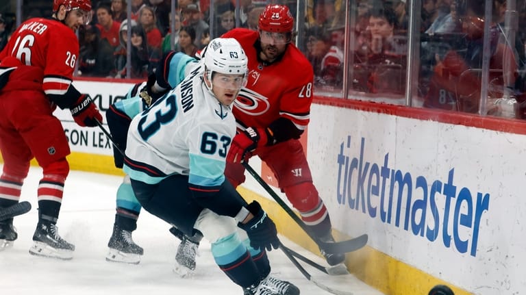 Carolina Hurricanes' William Carrier (28) clears the puck past Seattle...