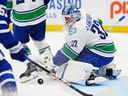 Vancouver Canucks goaltender Kevin Lankinen makes save against Toronto Maple Leafs on Saturday at Scotiabank Arena in relief of injured Thatcher Demko.