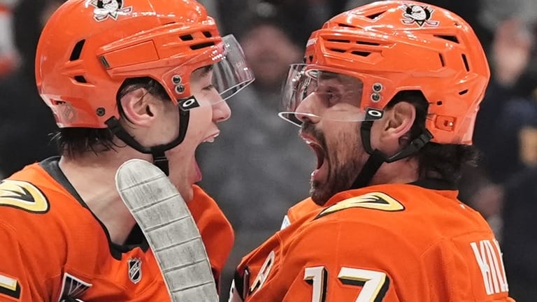Anaheim Ducks right wing Beckett Sennecke, left, celebrates his goal...