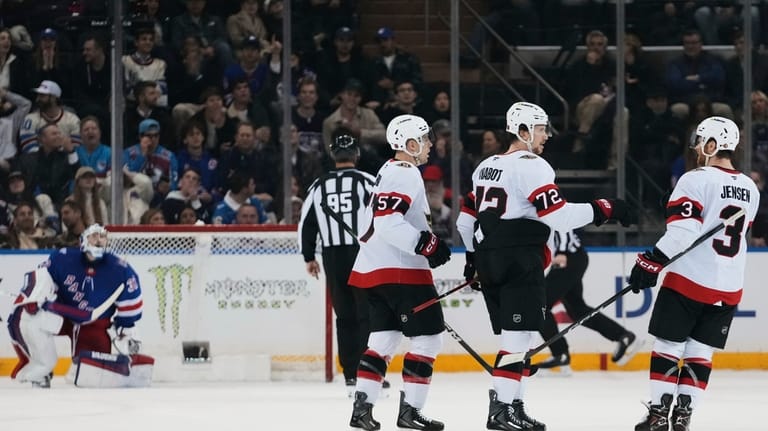Ottawa Senators' Thomas Chabot (72) celebrates with David Perron (57)...