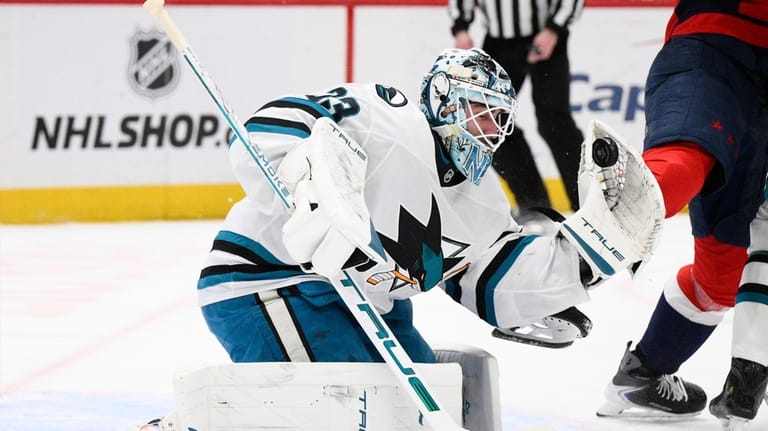 San Jose Sharks goaltender Alex Nedeljkovic (33) stops the puck...