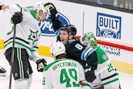 Utah Mammoth center Nick Schmaltz (8) celebrates a goal by teammate defenseman John Marino...