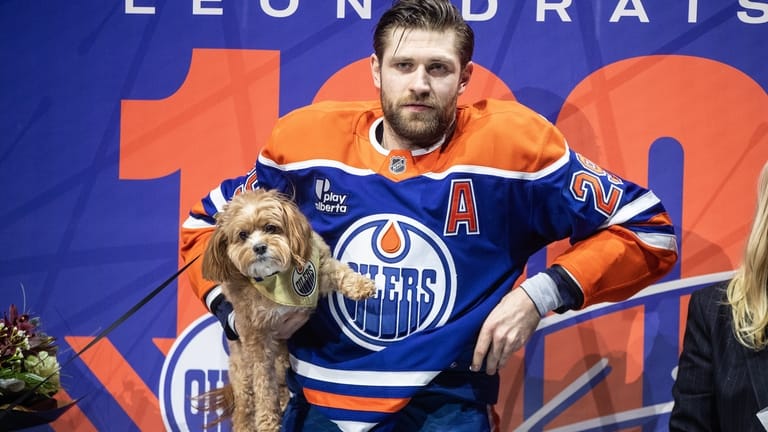 Edmonton Oilers' Leon Draisaitl stands with his dog before being...