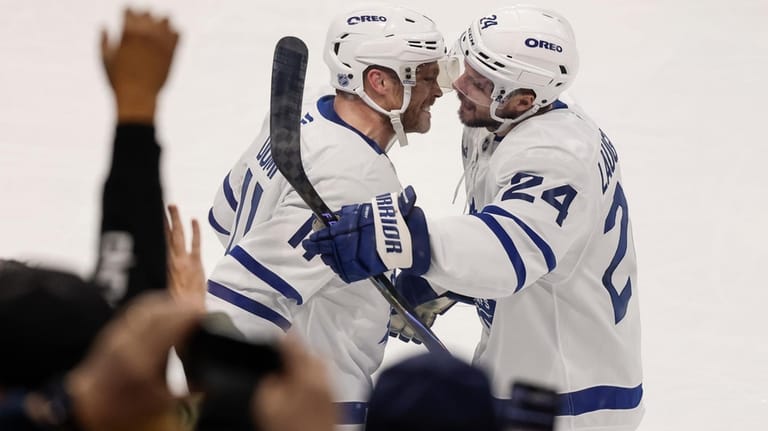 Toronto Maple Leafs' Max Domi (11) and Scott Laughton (24)...