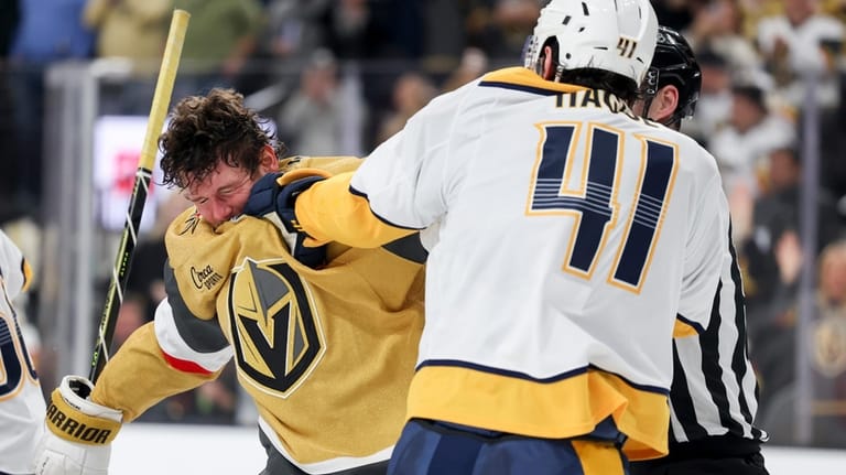 Vegas Golden Knights defenseman Jeremy Lauzon, left, and Nashville Predators...