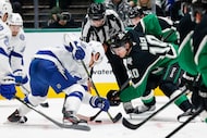 Dallas Stars center Oskar Bäck (10) and Tampa Bay Lightning center Jake Guentzel (59)...