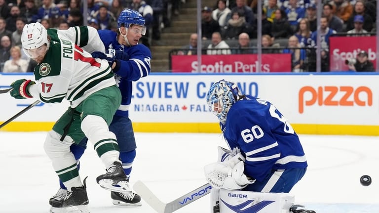 Toronto Maple Leafs goaltender Joseph Woll (60) makes a save...