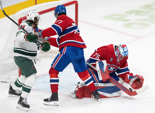 Montreal Canadiens goaltender Jakub Dobes (75) makes a save as Minnesota Wild