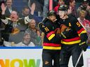 Evander Kane is congratulated by Tyler Myers after scoring a goal against the Washington Capitals during the first period at Rogers Arena on Wednesday night. The Canucks won 4-3.
