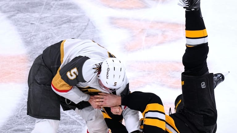 Boston Bruins center Mark Kastelic (47) is dropped to the...