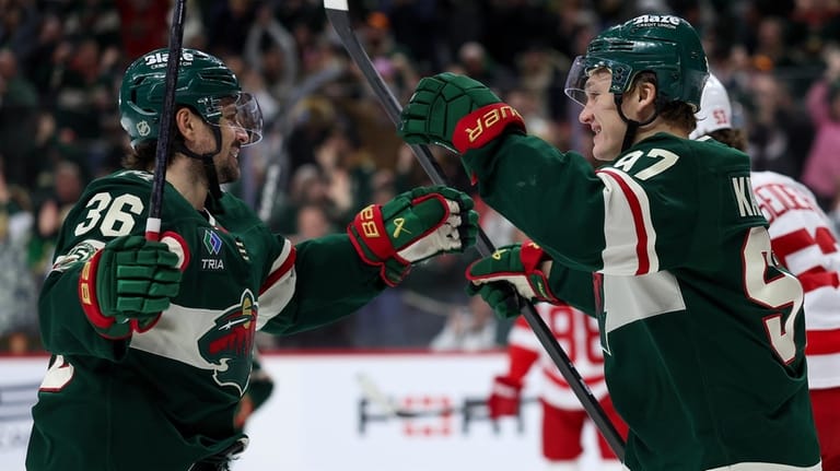 Minnesota Wild right wing Mats Zuccarello, left, celebrates his goal...