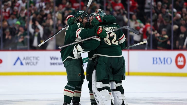 Minnesota Wild defenseman Brock Faber, goaltender Filip Gustavsson and center...