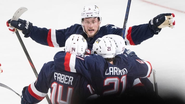 United States' Jack Eichel skates in to celebrate the empty...