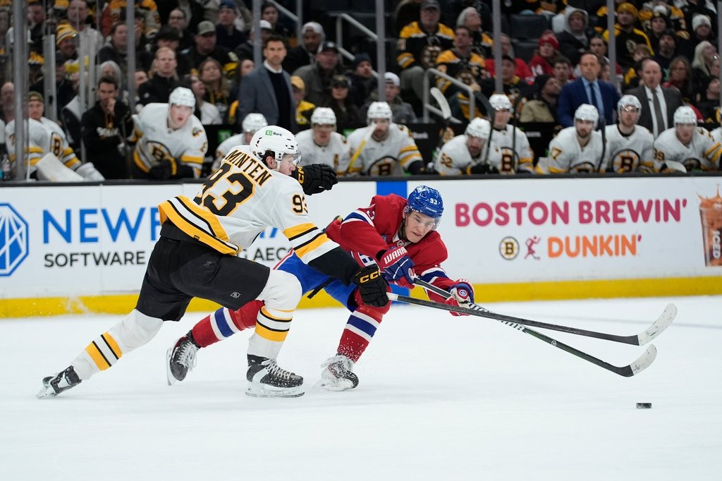 Montreal Canadiens right wing Ivan Demidov, right, gets off a pass while being defended by Boston Bruins centre Fraser Minten, left, during the third period of an NHL hockey game in Boston, Saturday, Jan. 24, 2026. (AP Photo/Robert F. Bukaty)