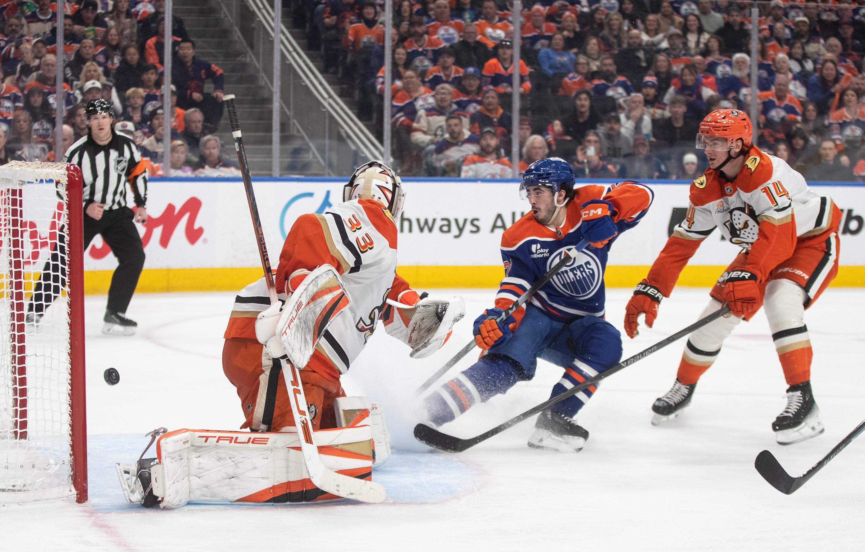 Ducks goaltender Ville Husso, left, is scored on as the...