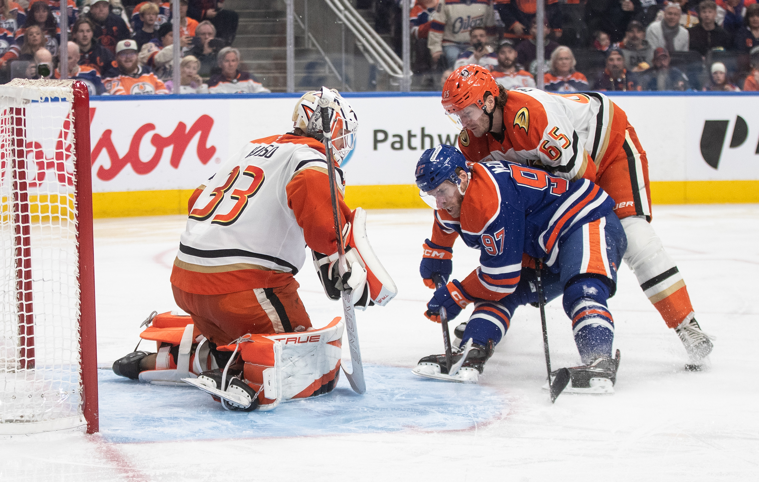 Ducks goaltender Ville Husso, left, makes a save on the...