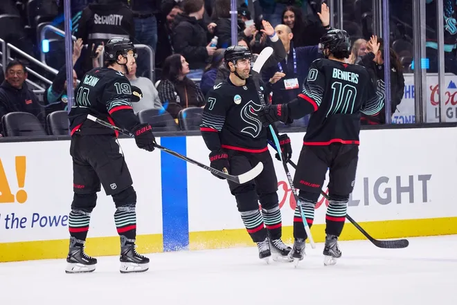 Jan 25, 2026; Seattle, Washington, USA; Seattle Kraken right wing Jordan Eberle (7) celebrates with Seattle Kraken center Matty Beniers (10) and Seattle Kraken left wing Jared McCann (19) after scoring an empty net goal during the third period against the New Jersey Devils at Climate Pledge Arena.