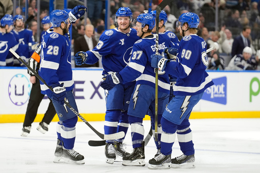 Tampa Bay Lightning defenseman Darren Raddysh (43, second from left) celebrates his goal against the Winnipeg Jets with teammates, including center Zemgus Girgensons (28), center Yanni Gourde (37) and defenseman J.J. Moser (90) during the second period of an NHL hockey game Thursday, Jan. 29, 2026, in Tampa, Fla. (AP Photo/Chris O