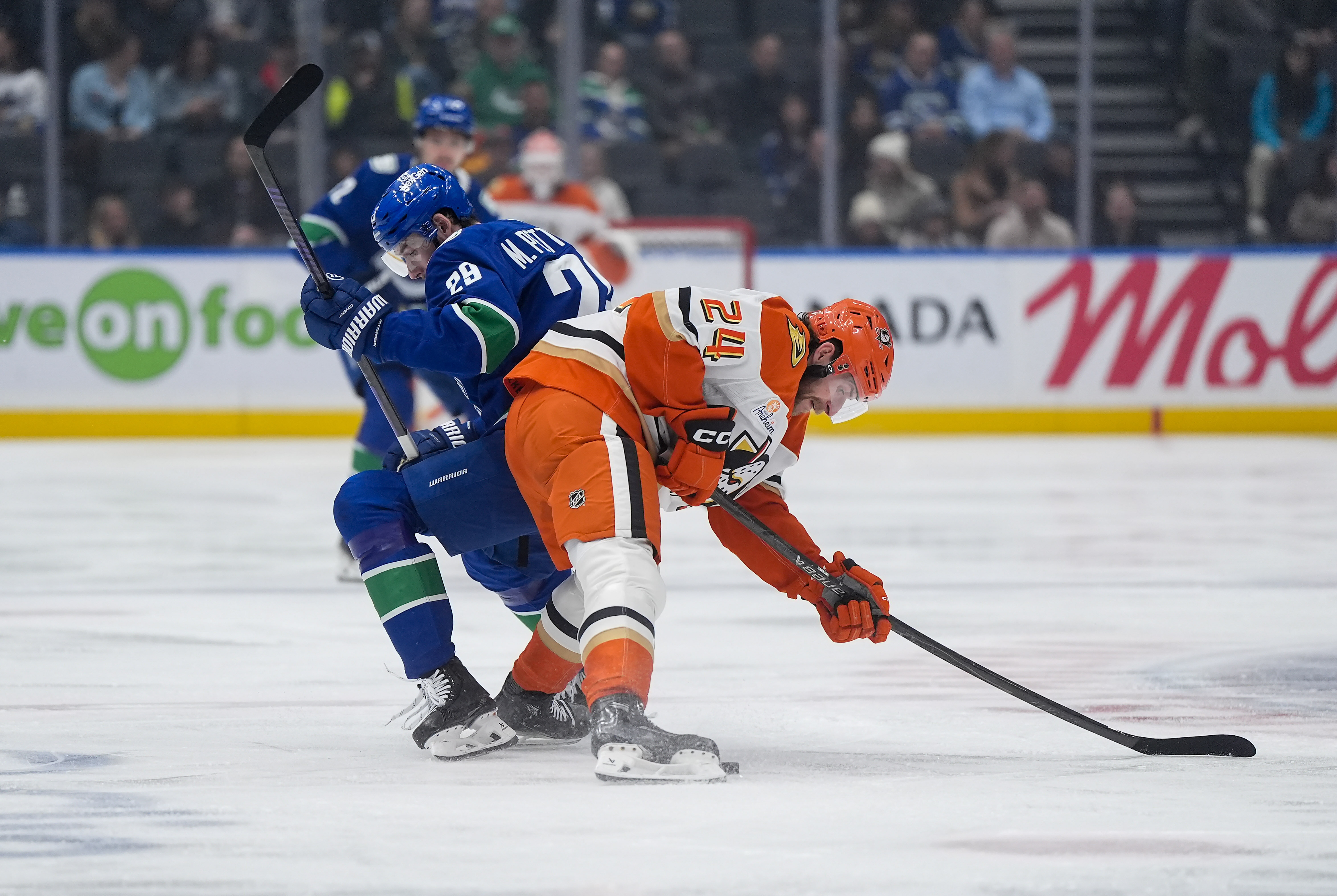 The Vancouver Canucks’ Marcus Pettersson, left, and the Ducks’ Jansen...