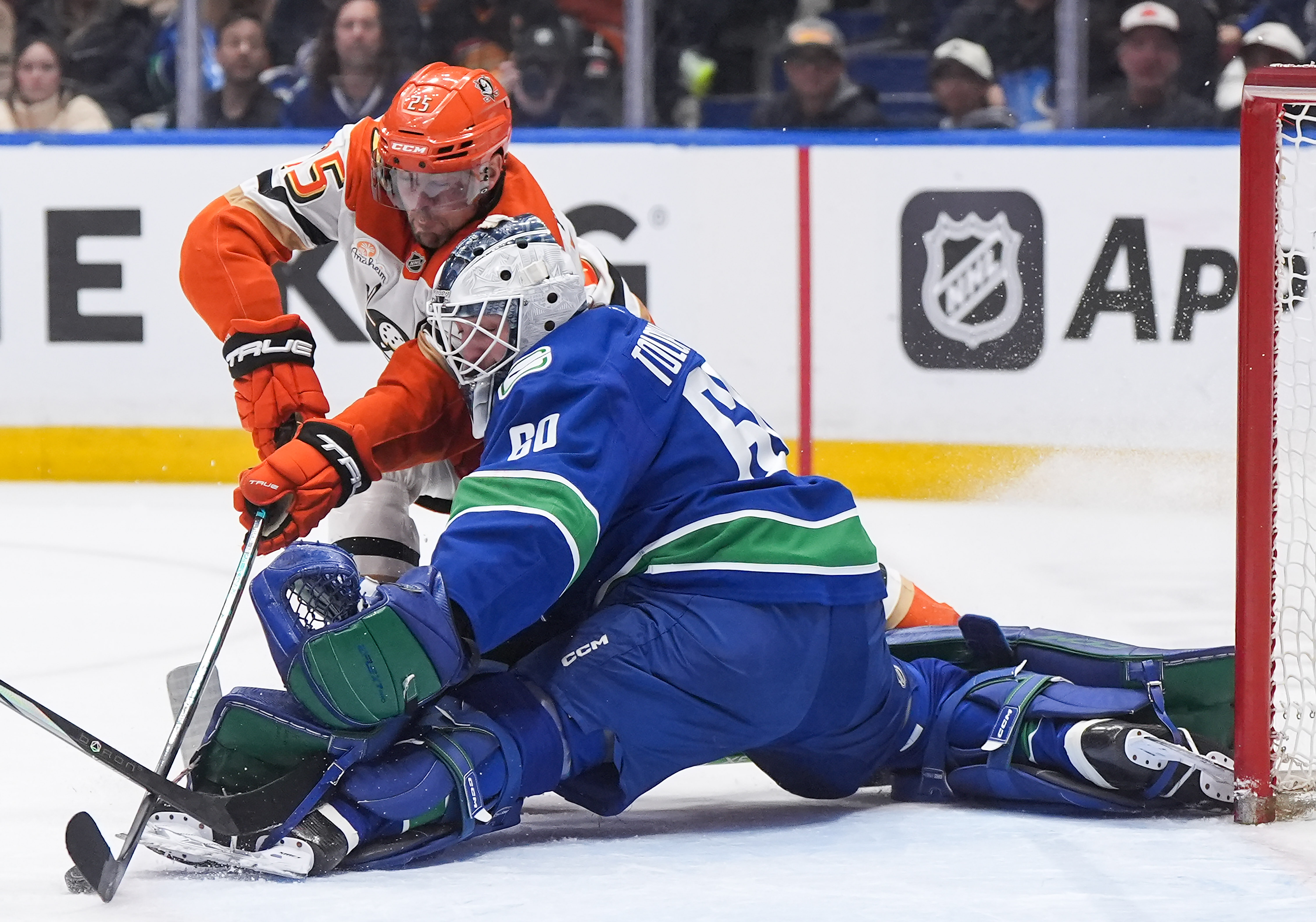 Vancouver Canucks goalie Nikita Tolopilo, right, stops the Ducks’ Ryan...