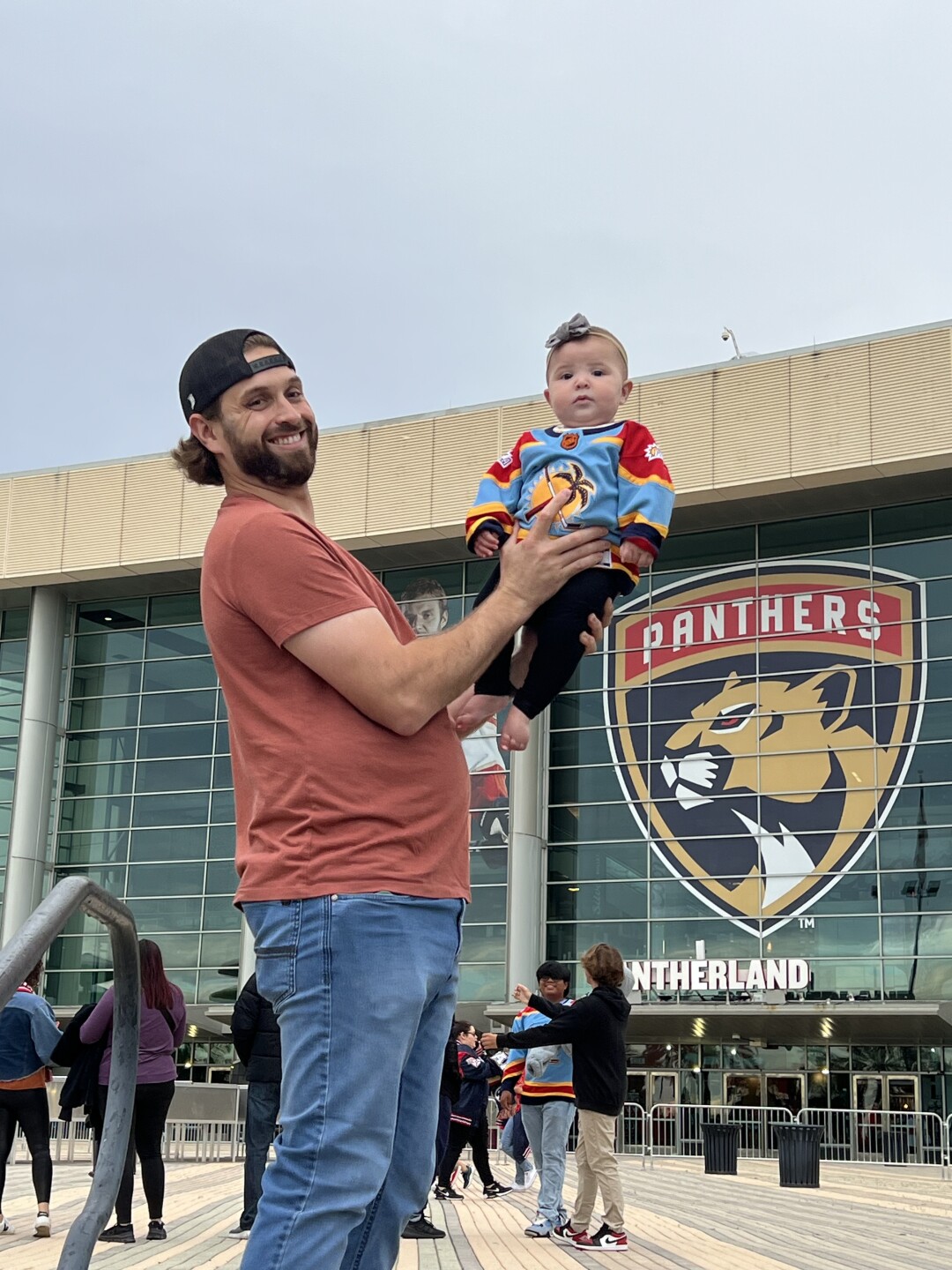 Matthew Alfredson with his child at Amerant Bank Arena in Sunrise.jpg