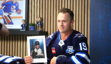Winnipeg Jets forward Jonathan Toews holds a photo of himself as young hockey player during a press conference on Friday at Canada Life Centre on Friday to officially announce he had signed with his hometown team. (Ruth Bonneville/Winnipeg Free Press)