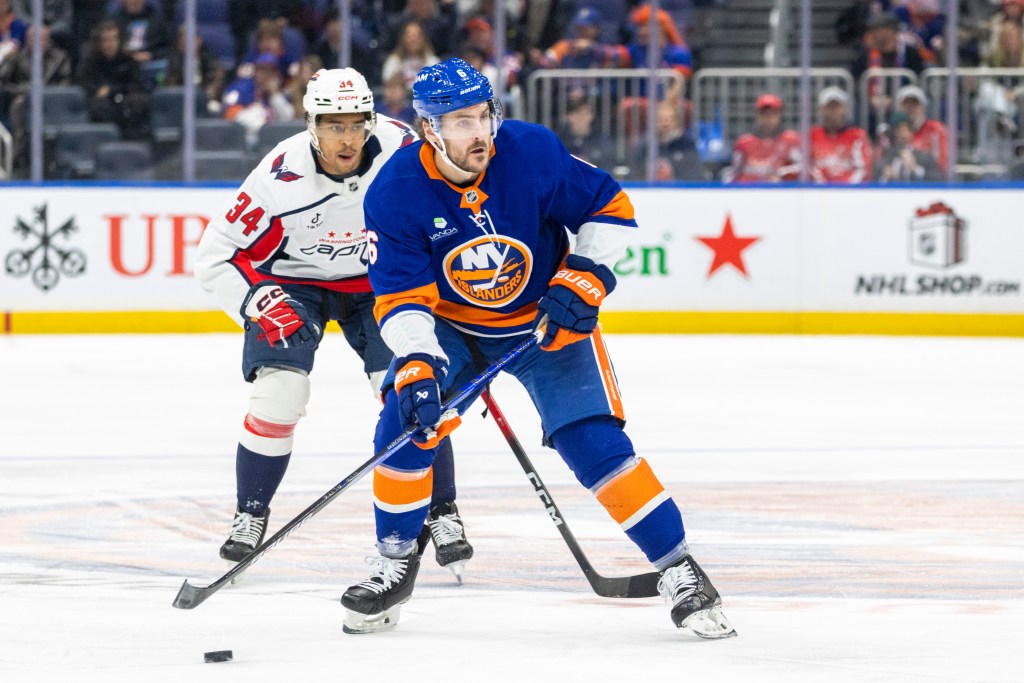 New York Islanders defenseman Ryan Pulock (6) skates in front of Washington Capitals right wing Justin Sourdif (34) during the first period at UBS Arena, Sunday, Nov. 30, 2025, in Elmont, NY.